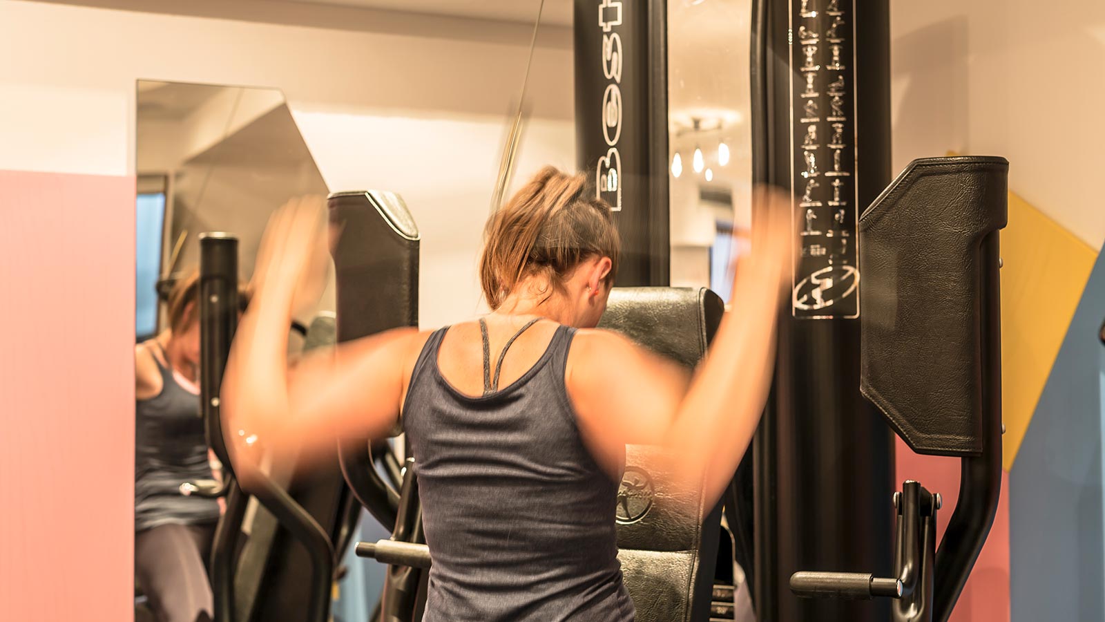 A girl is working out at the gym of Hotel Maibad in Vipiteno